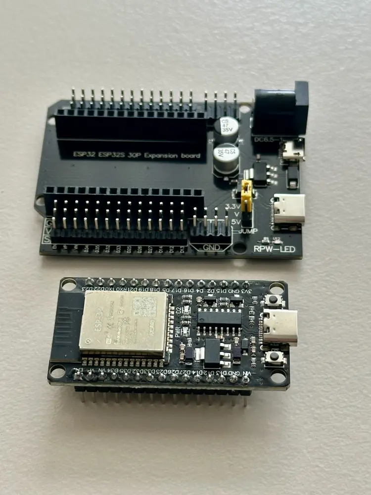 Draufsicht auf ein loses ESP32 NodeMCU Development Board mit USB-C neben einer passenden schwarzen Expansion-Board-Erweiterungsplatine